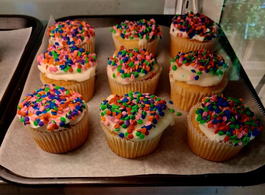 Vanilla cupcakes topped with colorful celebration sprinkles