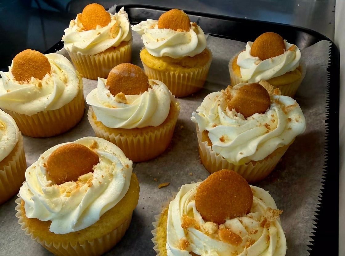 Cupcakes topped with swirled frosting and a vanilla wafer