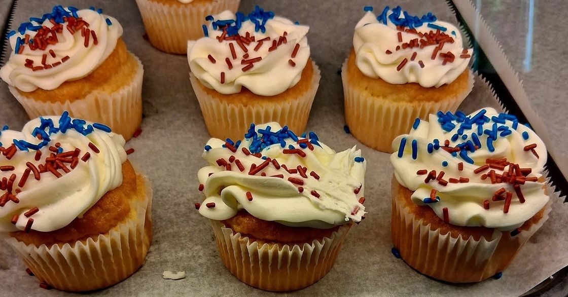 Vanilla cupcakes with festive red and blue sprinkles