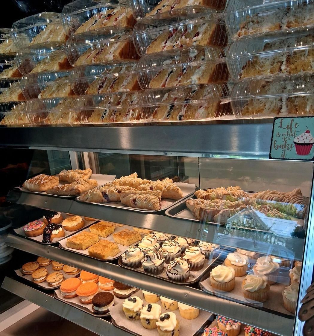 Assorted cupcakes and pastries in the Twisted Whisk display case