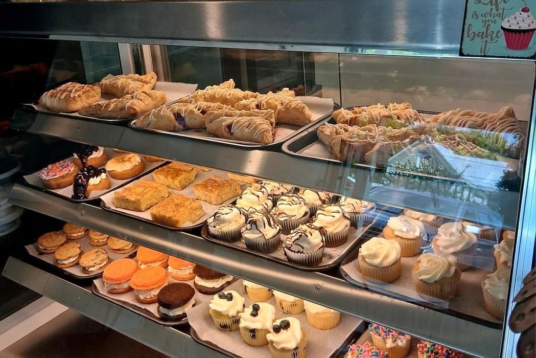 Assorted cupcakes and pastries in the Twisted Whisk display case