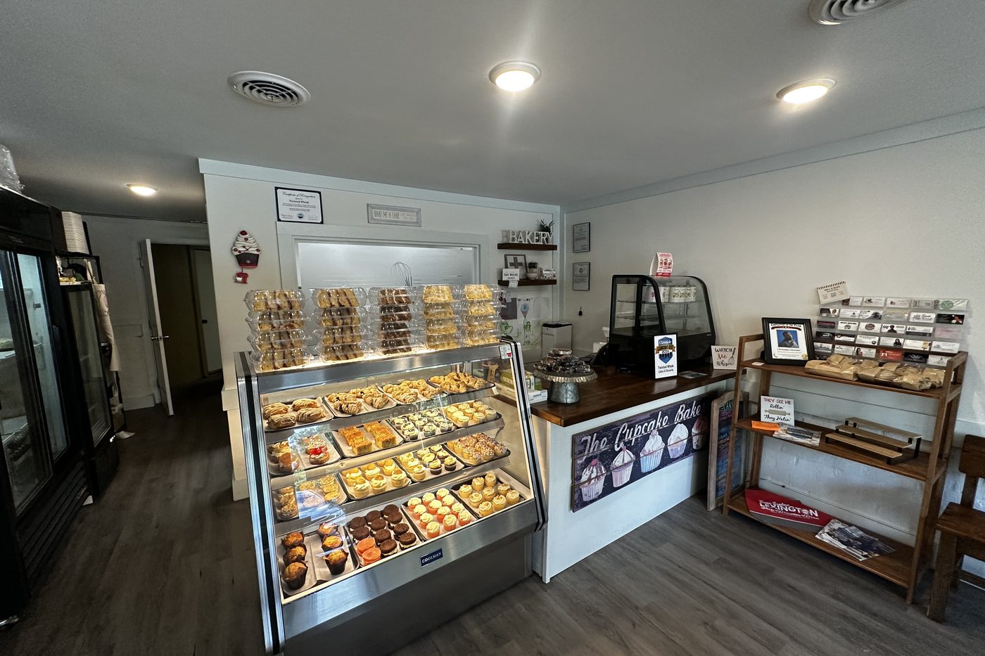Inside the Twisted Whisk shop — the case, the counter and a place to sit